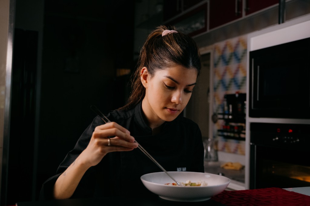 Chef Rashi Kaur plating a dish